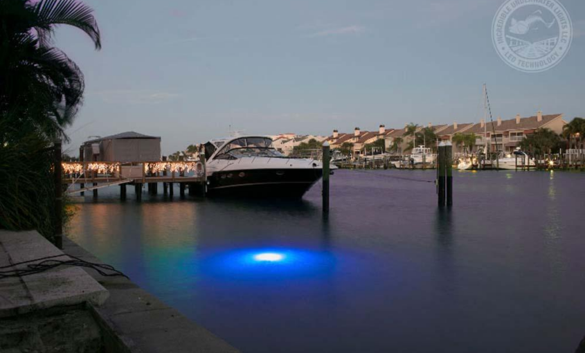 A blue colored LED light next to a boat.