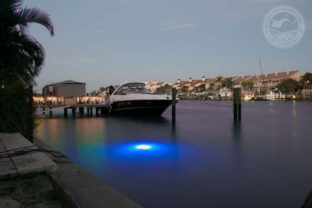 A blue colored LED light next to a boat.