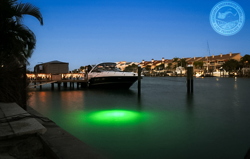 Light being illuminated in water next to a boat