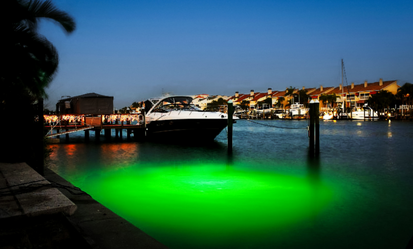 Underwater LED light in front of a boat in water